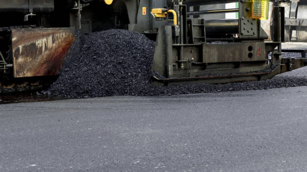 Industrial pavement truck laying fresh asphalt stock photo