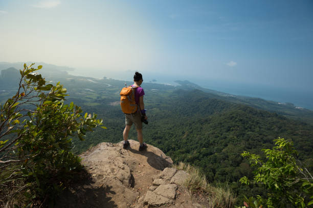 istock young woman backpacker enjoy the view on sunrise mountain peak 665394740