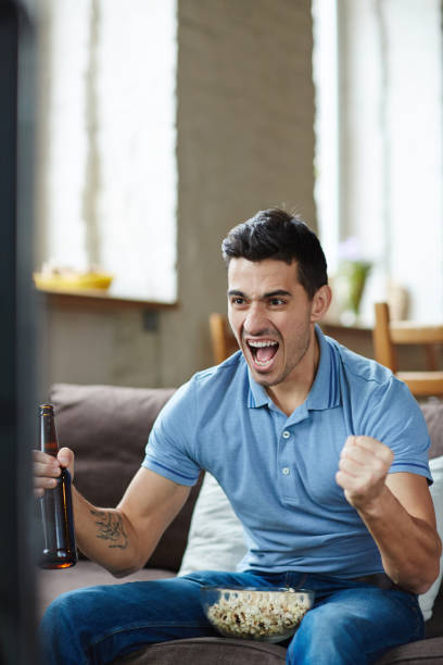 istock Emotional Man Watching Sports 665397360