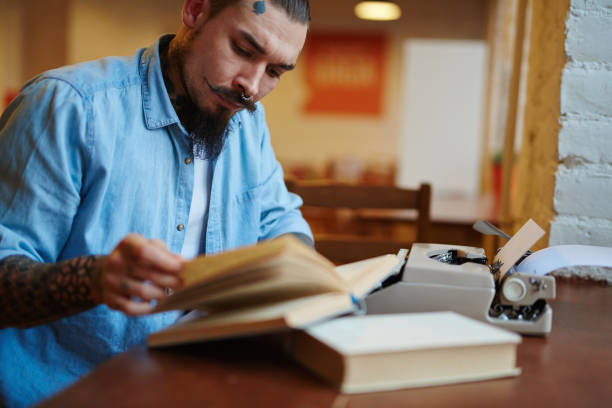 istock Hipster Old-School Writer Working on His Book 665397378
