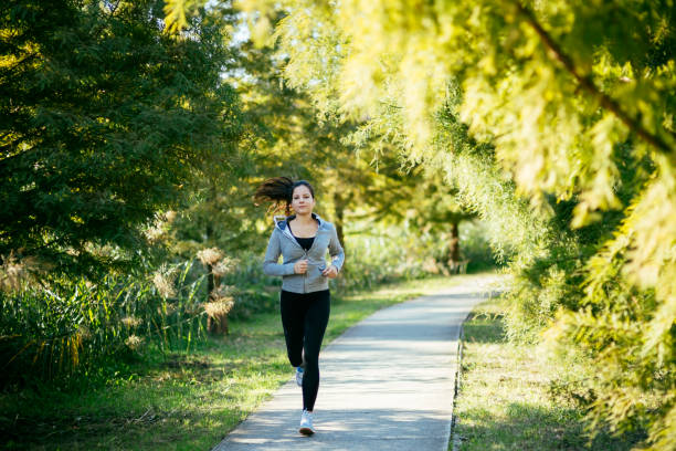 istock Beautiful woman jogging in  a park 665401636
