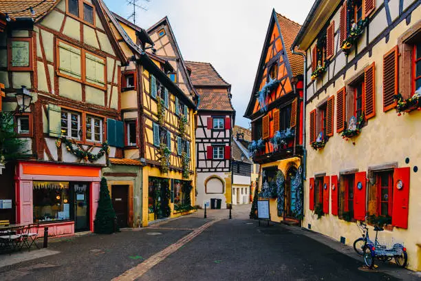 Street view with traditional half timbered colorful houses with noel ornaments of Colmar in the region of Alsace on the French border with Germany.