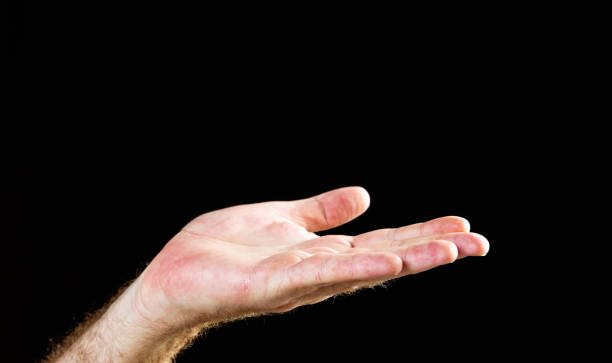 istock Hand signs: hand held out in appeal against black 665405316