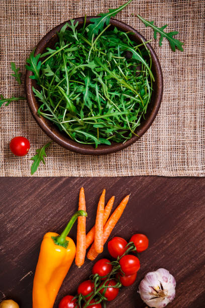 istock Green arugula leaves in bowl. Fresh salad. 665405382