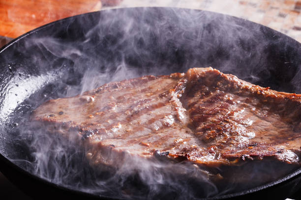 istock Beef steak fry in smoke and steam 665406608