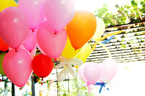 Mid adult woman holding a balloon on a party