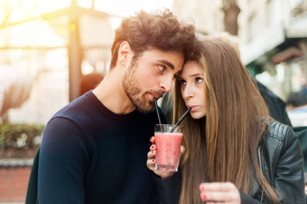 istock Couple on a date sharing cocktail 665407010