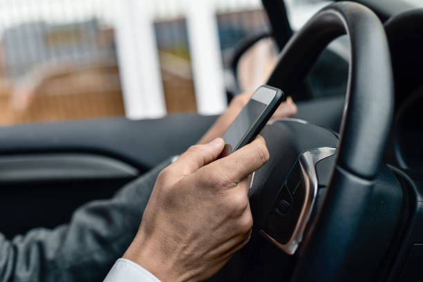 istock businessman using a smartphone in a car 665410652