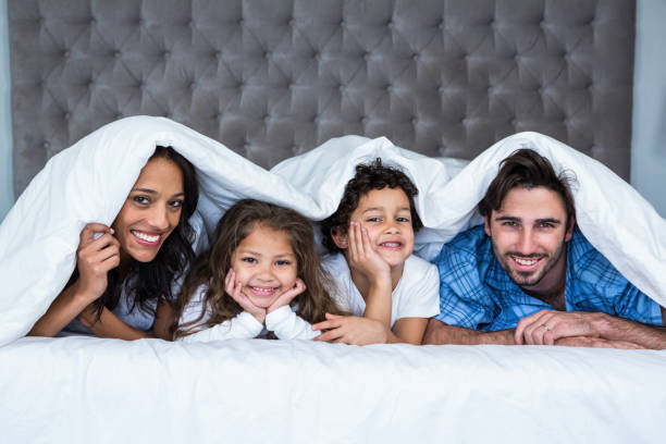 istock Happy family under the blanket 665411804