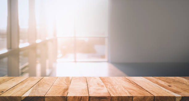istock Wood table top on glass wall abstract background. 665414476