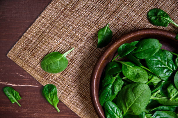 istock Spinach leaves in bowl. Raw fresh vegetable. 665414716