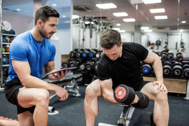 istock Fit man working out in weights room 665418336