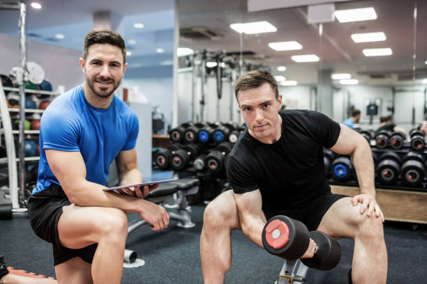 istock Fit man working out in weights room 665418418