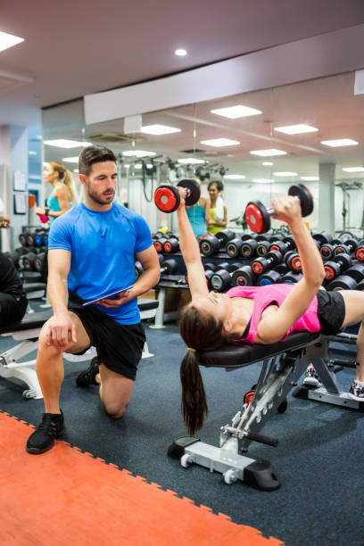istock Fit people working out in weights room 665421834