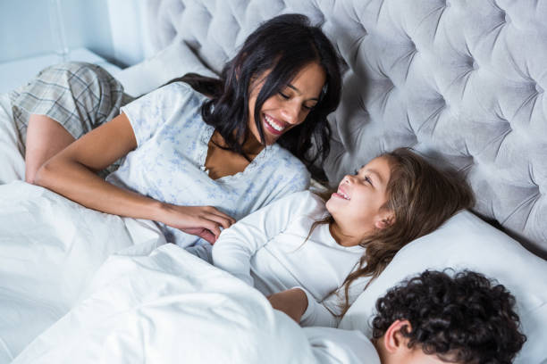 istock Happy family in bed waking up 665422234