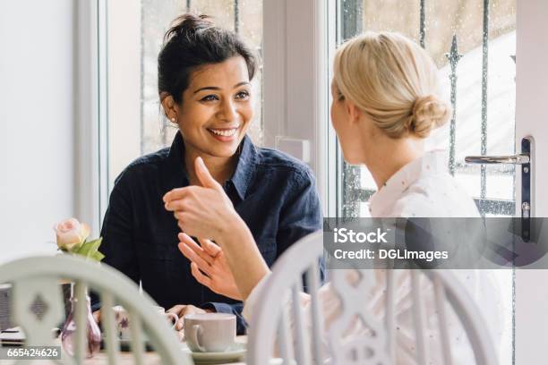 Friends In A Cafe Stock Photo - Download Image Now - Discussion, Talking, Friendship