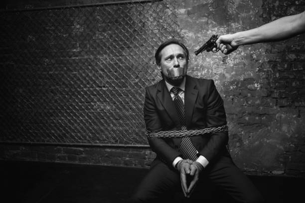 istock Pathetic broken businessman afraid of his kidnapper 665431054