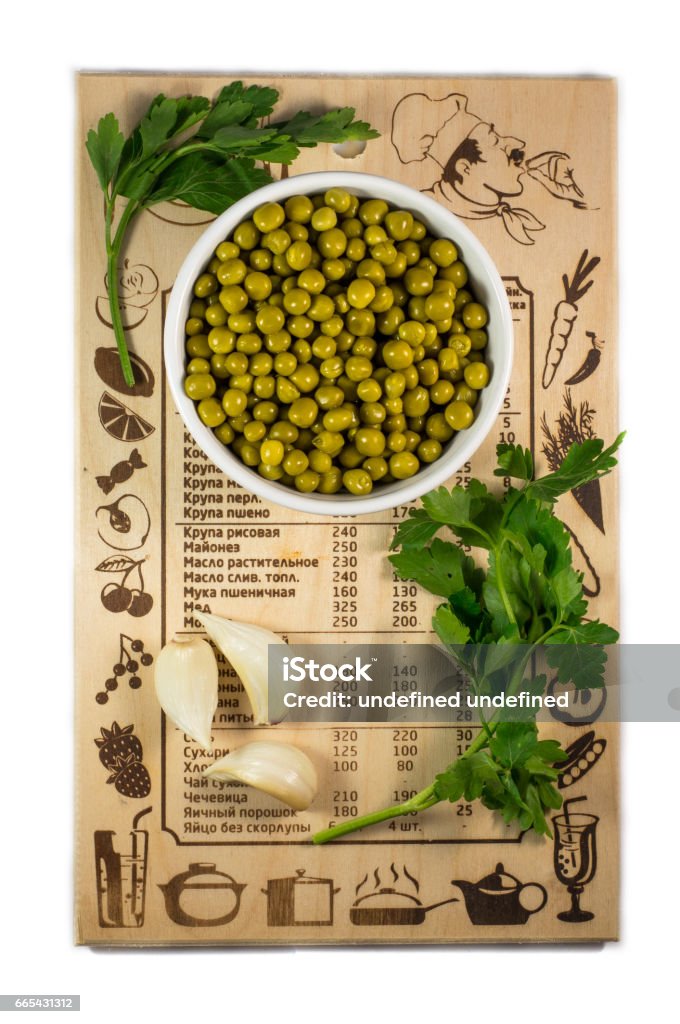 Peas on a cutting board on a white background. Vegetables on the board. Backgrounds Stock Photo