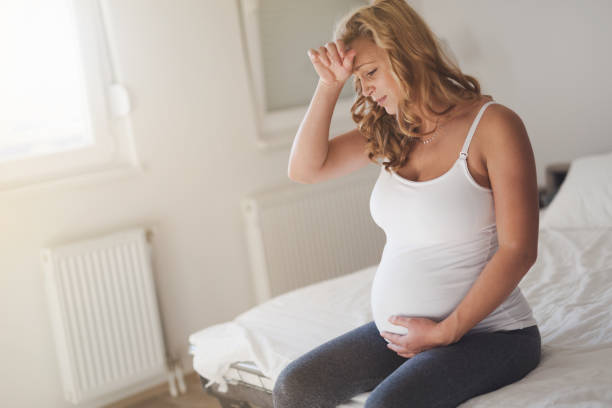 istock Pregnant woman suffering with headache and nausea 665431892