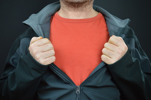 man showing his red t-shirt under a black jacket with empty space for a message