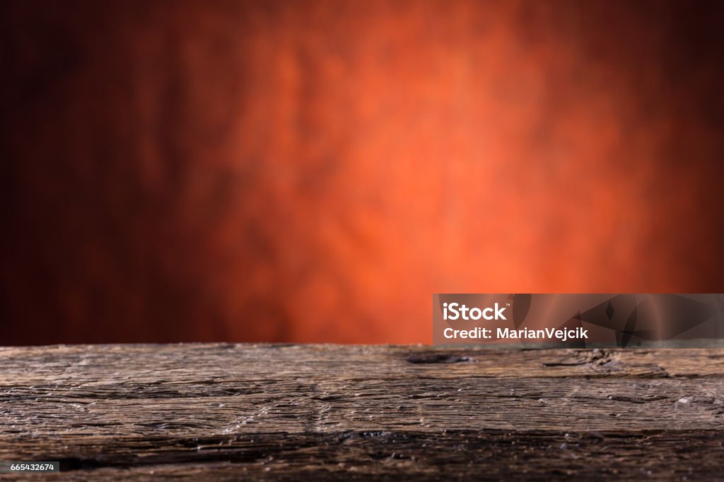 Empty wooden oak table and abstract red orange background.Free space for your product or information"n Empty wooden oak table and abstract red orange background.Free space for your product or information. Barrel Stock Photo