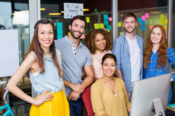 istock Smiling graphic designers working at desk in office 665436854