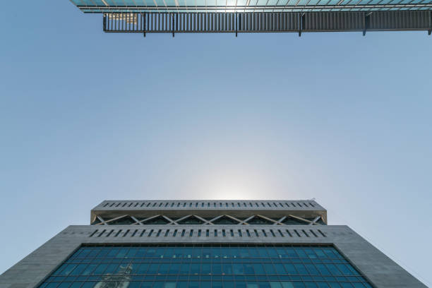 Infinite Corporate Buildings. Business offices skyscrapers on blue sky background. Low angle view of tall corporate buildings. stock photo