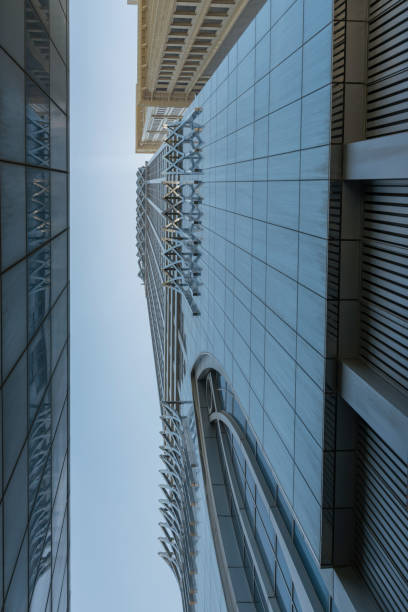 Infinite Corporate Buildings. Business offices skyscrapers on blue sky background. Low angle view of tall corporate buildings. stock photo