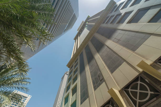 Infinite Corporate Buildings. Business offices skyscrapers on blue sky background. Low angle view of tall corporate buildings. stock photo