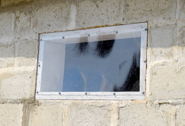 A window made of plexiglas in a concrete wall.