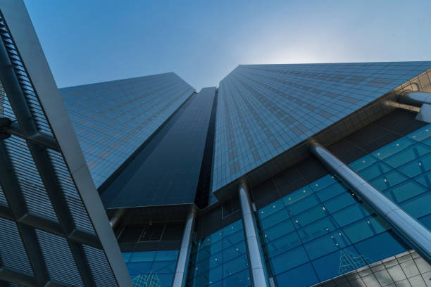 Infinite Corporate Buildings. Business offices skyscrapers on blue sky background. Low angle view of tall corporate buildings. stock photo