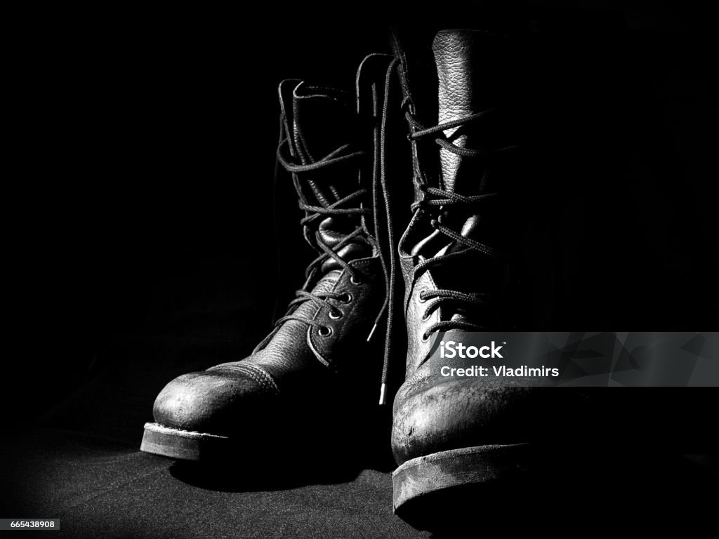 Military leather boots over black background Military leather boots, army uniform shoes over black background Boot Stock Photo