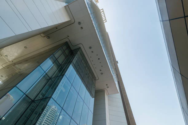 Infinite Corporate Buildings. Business offices skyscrapers on blue sky background. Low angle view of tall corporate buildings. stock photo