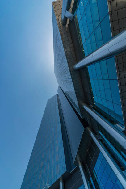 Infinite Corporate Buildings. Business offices skyscrapers on blue sky background. Low angle view of tall corporate buildings. stock photo