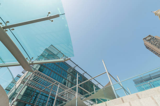 Infinite Corporate Buildings. Business offices skyscrapers on blue sky background. Low angle view of tall corporate buildings. stock photo