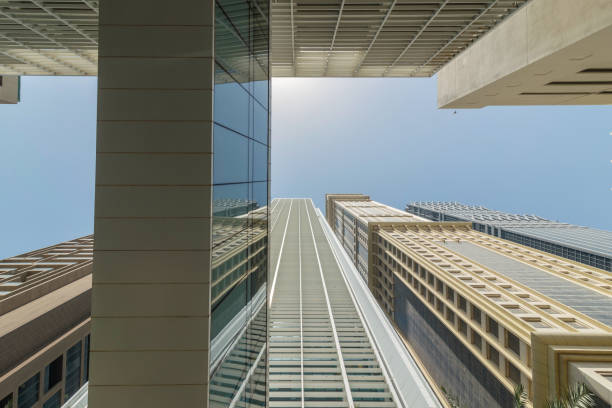 Infinite Corporate Buildings. Business offices skyscrapers on blue sky background. Low angle view of tall corporate buildings. stock photo