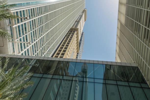 Infinite Corporate Buildings. Business offices skyscrapers on blue sky background. Low angle view of tall corporate buildings. stock photo