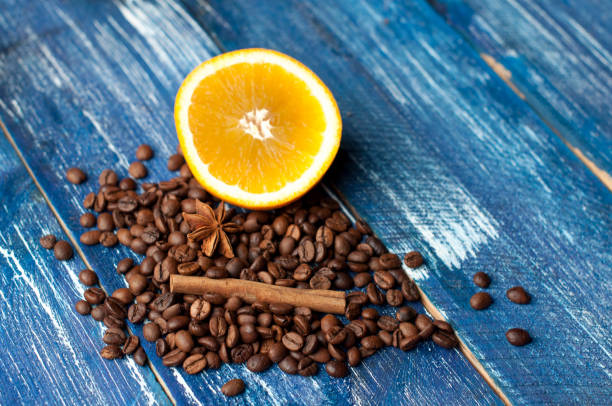 istock Aromatic composition of oranges, cinnamon and coffee beans on a dark blue background. Top view 665444800