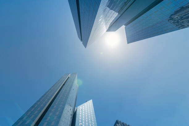 Infinite Corporate Buildings. Business offices skyscrapers on blue sky background. Low angle view of tall corporate buildings. stock photo