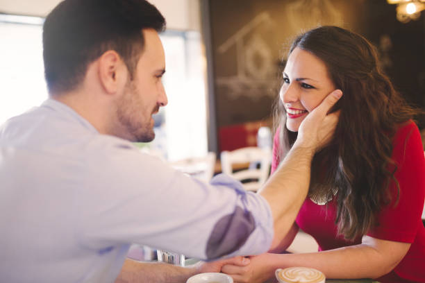 istock Cheerful romantic couple flirting and smiling  in cafe 665449262