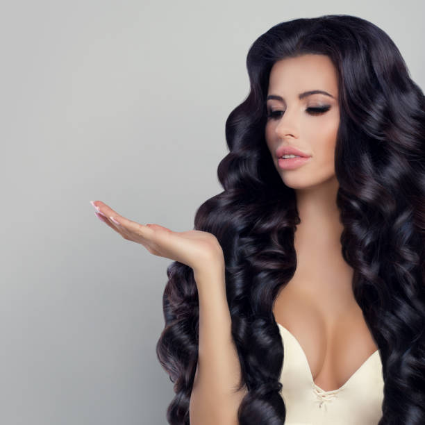 istock Beautiful Woman Showing her Empty Hand 665455900