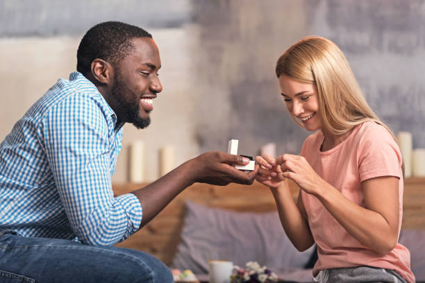 istock Overwhelmed young African American couple getting engaged at home 665459546