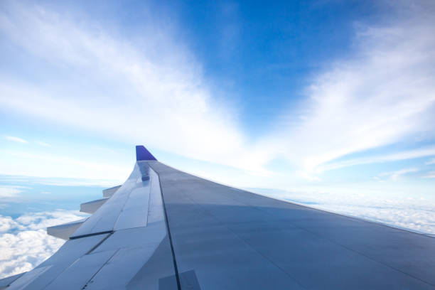 istock Airplane wing flying above the cloud i 665472426
