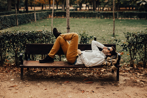 Man relaxing in park, enjoying beautiful day outdoors