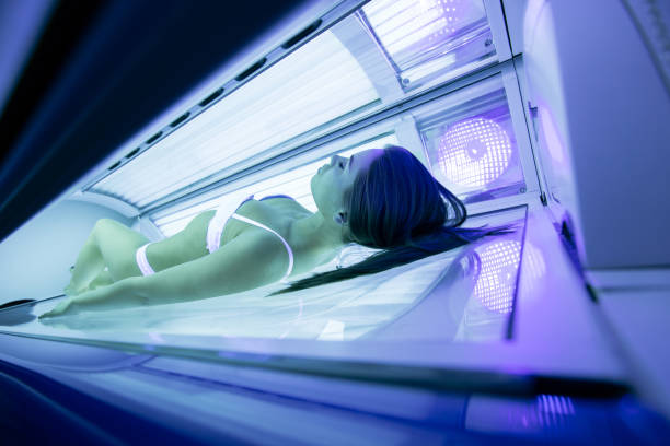 istock Beautiful sexy  brunette sunbathing in solarium 665477026