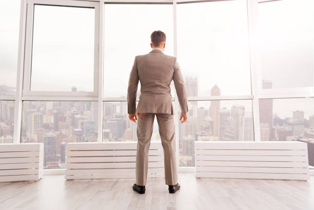 istock Confident businessman standing in his office 665493996