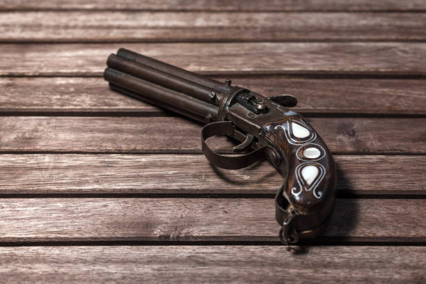 istock Old, retro gun on wooden background 665494256