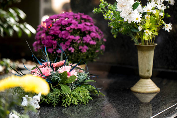 Flowers on the grave Flowers and funeral bouquets on the grave. pics of guardian angels stock pictures, royalty-free photos & images