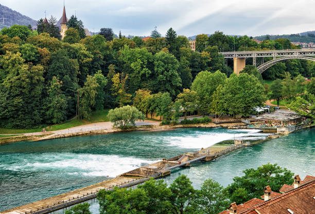 Dam on Aare River, Kirchenfeld bridge and Historical Museum in Bern, Switzerland. Seen from Bundesterrasse