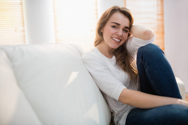 istock Smiling woman posing on the couch 665498354